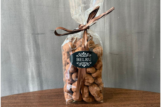 Bag of cookies with a visible brand label on a wooden surface and gray background
